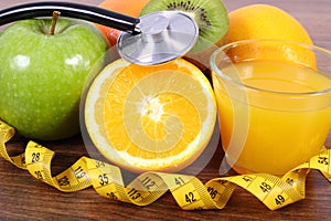 Stethoscope, fresh fruits, juice and centimeter, healthy lifestyles and nutrition