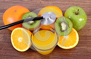 Stethoscope, fresh fruits and juice, healthy lifestyles and nutrition