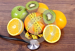 Stethoscope, fresh fruits and tape measure, healthy lifestyles and nutrition