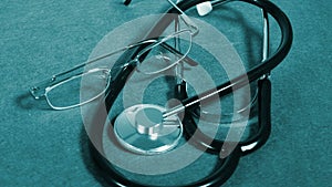 Stethoscope and glasses on table
