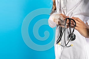 Stethoscope in a hand held by a young GP