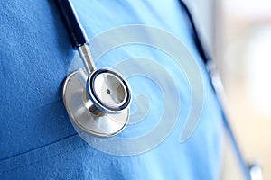 Stethoscope head lying on medicine therapeutist doctor chest