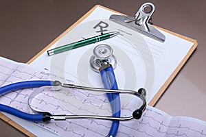 Stethoscope head and silver pen lying on cardiogram clipboard pad. Cardio therapeutist assistance, physician make cardiac physica