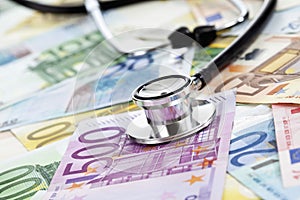 Stethoscope on heap of euro notes