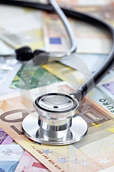 Stethoscope on heap of euro notes