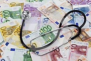 Stethoscope on heap of euro notes