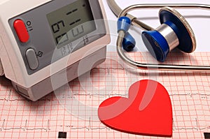 Stethoscope, heart shape, blood pressure monitor on electrocardiogram