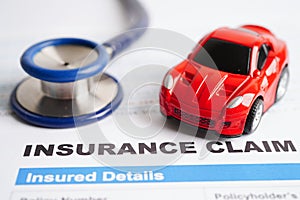 Stethoscope on Insurance claim accident car form, Car loan, insurance and leasing time concepts