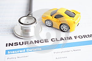 Stethoscope on Insurance claim accident car form, Car loan, insurance and leasing time concepts