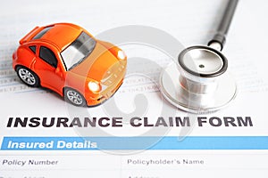 Stethoscope on Insurance claim accident car form, Car loan, insurance and leasing time concepts