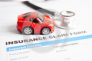 Stethoscope on Insurance claim accident car form, Car loan, insurance and leasing time concepts