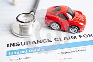 Stethoscope on Insurance claim accident car form, Car loan, insurance and leasing time concepts