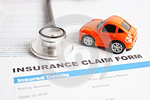 Stethoscope on Insurance claim accident car form, Car loan, insurance and leasing time concepts