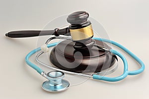 Stethoscope with judge gavel on gray