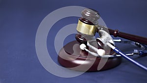 Stethoscope and judgement hammer. Gavel and stethoscope. medical jurisprudence. legal definition of medical malpractice photo