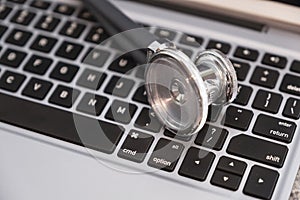 Stethoscope on keyboard countertop ready for use and data entry