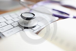 Stethoscope keyboard and diary on the table. photo