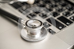 Stethoscope on laptop computer keyboard, Medical health concept