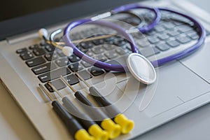 Stethoscope on laptop keyboard. Health care or IT security concept. Laptop repair concept. Computer repair concept Close-up view.