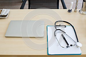 Stethoscope and laptop and other medical object on table of doctor