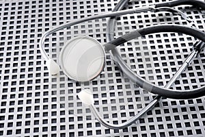 Stethoscope on a latticed metal surface photo