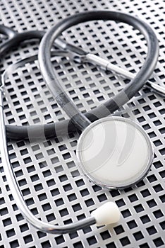 Stethoscope on a latticed metal surface photo