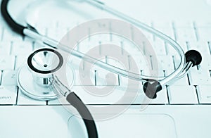 Stethoscope laying on keyboard