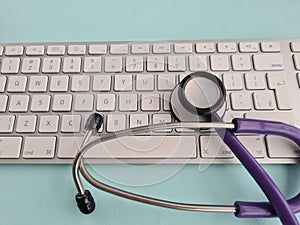 Stethoscope lies on computer keyboard in doctor office closeup and telemedicine