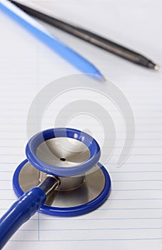 A stethoscope on lined study paper