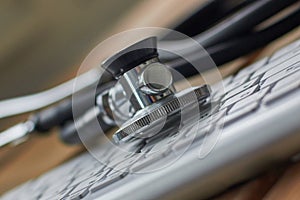 Stethoscope lying at the computer keyboard close up.