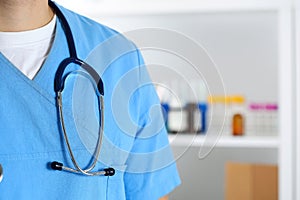 Stethoscope lying on male medicine therapeutist doctor chest