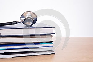 Stethoscope lying on pile of planners