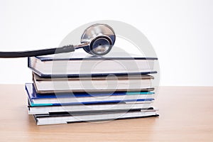 Stethoscope lying on pile of planners