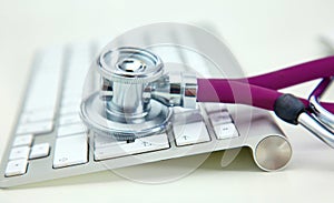 Stethoscope lying on a table an open book