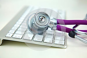 Stethoscope lying on a table on an open book