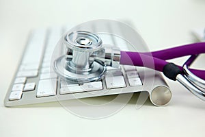 Stethoscope lying on a table an open book