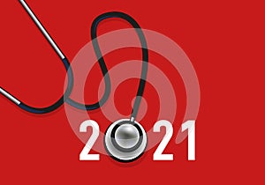 Greeting card 2021, on the theme of health symbolized by a stethoscope on a red background. photo