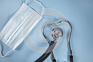 Stethoscope with medical mask  on table