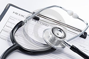 Stethoscope and medical record on white background.