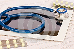 Stethoscope with medical tablet and pills