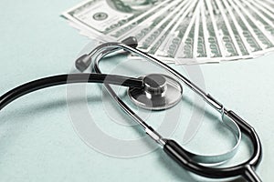 Stethoscope and money, concept. Paid medicine. Costs for the medical insurance