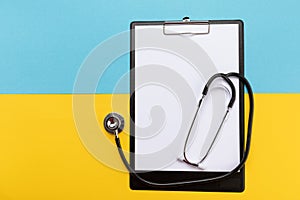 Stethoscope on the national flag of Ukraine blue and yellow