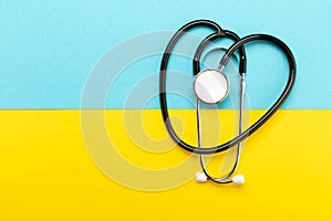 Stethoscope on the national flag of Ukraine blue and yellow