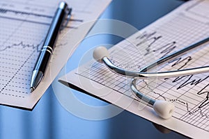 Stethoscope on a notebook. Medical cardiogram