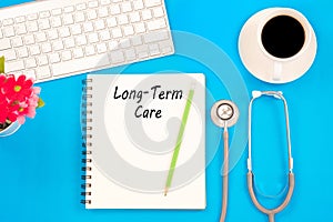 Stethoscope on notebook and pencil with Long Term Care words as photo