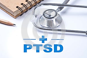 Stethoscope, notebook and pencil with PTSD - post traumatic stress disorder words. Medical concept. War veteran mental health iss photo