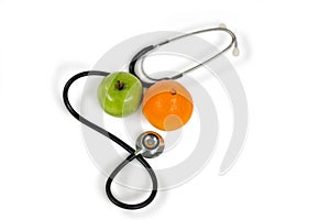 Stethoscope, orange, apple on white background