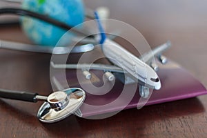 Stethoscope , passport document, airplane and globe. Global Healthcare and travel insurance concept