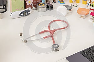 Stethoscope and pediatric equipment, on the desk of a pediatric office photo