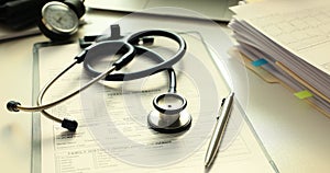 Stethoscope and pen on medical records in doctor office
